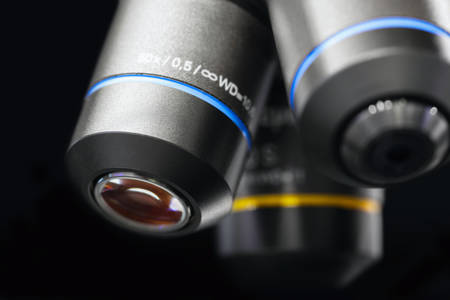Close up of examining of test sample under the microscope in laboratory.の写真素材