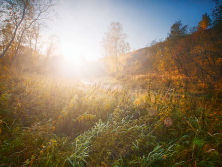 Misty dawn at the autumn summer riverの写真素材