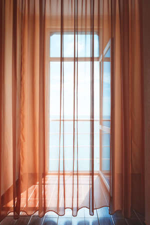 Hotel room with sea view house near sea in environmental  location on  island. window overlooking the ocean. endless expanse of  sea. Place romantic holiday. Blurred toning in vintage dreamy style.の写真素材