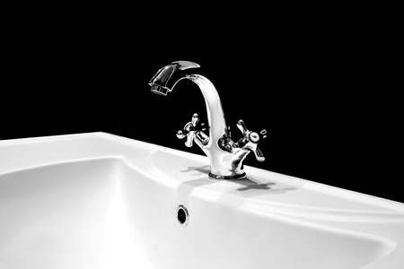 Luxury faucet mixer on a white sink in a beautiful black bathroomの写真素材