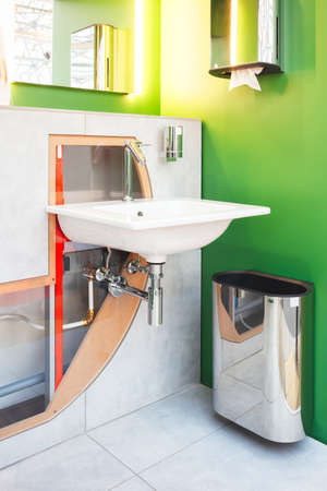 One of new white ceramic outdoor sink in public toilet install on the transparent wall. の写真素材