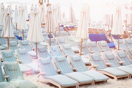 Deserted beach with plenty of beach chairs ay sunset ,Concept of relaxed leisure.