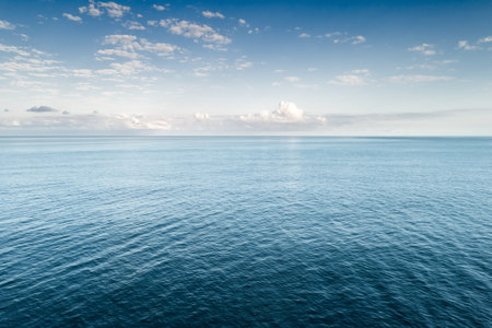 blue sea and cloudy sky over it
