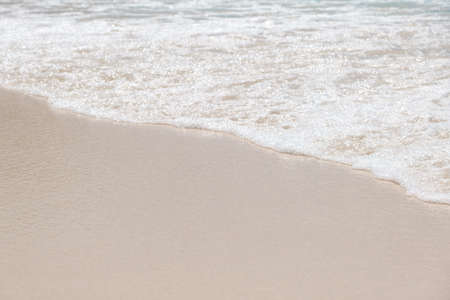 Blue ocean wave on sandy beachの写真素材