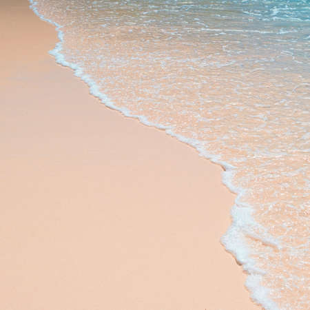 Blue ocean wave on sandy beachの写真素材