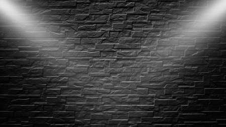 Highly contrasted spotlights on an outdoor black brick wallの写真素材