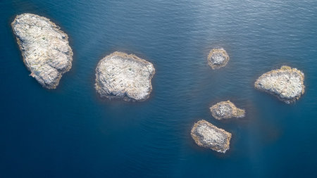Top view aerial photo from flying drone of many small islands, ocean with sunny rays and turquoise...