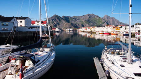 Scenic view of the waterfront harbor in Henningsvaer in summer. Henningsvaer is a fishing village...