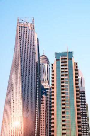 Abstract skyscrapers with sun glare toned in vintage style