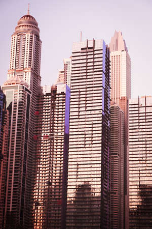 Abstract skyscrapers with sun glare toned in vintage styleの写真素材