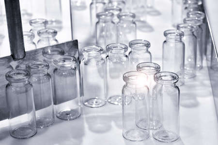 Empty bottles in the processing machine in pharmaceutical plantの写真素材
