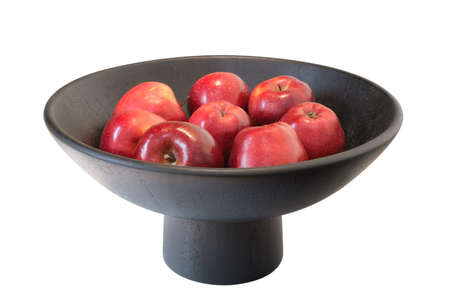 Red apples in black bowl, isolated on whiteの写真素材