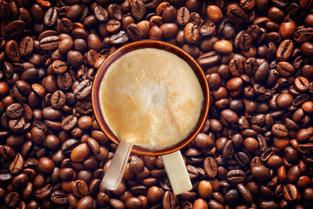 Cup of coffee on roasted coffee beans texture background. coffee concept