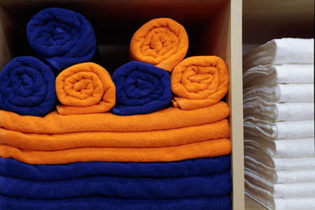 Colorful fresh Hotel Towels Folded and Stacked on a Shelfの写真素材