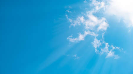 Beautiful blue sky with sunbeams and clouds.の写真素材