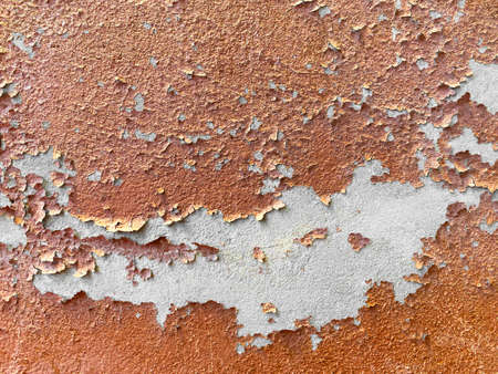 Old brick stucco wall with peeling plaster, grunge backgroundの写真素材
