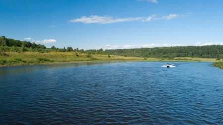 Landscape of banks of the river, speed boat on the river, summer day. View from above. Volga river...