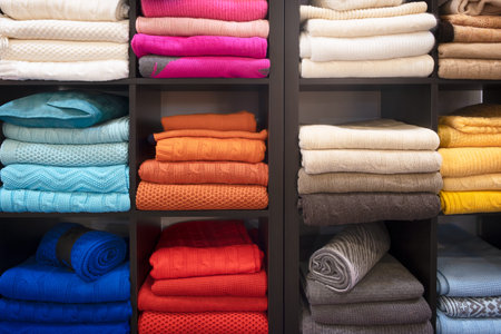 Row of colorful clothes on shelfの写真素材