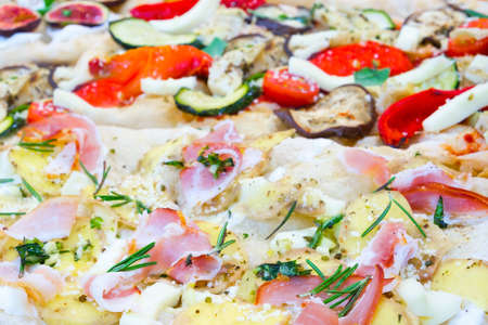 Italian fast food. Delicious hot pizza sliced and served on wooden platter with ingredients, close up view. Menu photo.の写真素材