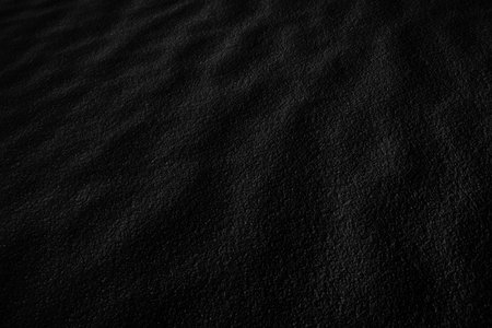 Black Sand dune. Black Sand beach macro photography. Background, texture, wave pattern of oceanic sand on the beach, black. Texture of beach sand. Black beach.の写真素材