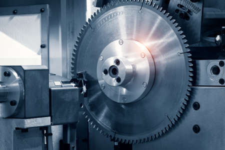 Automatic disksaw sawing metal workpiece, industrial concept backgroundの写真素材