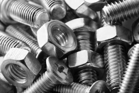 Abstract industrial textured metal background with many metal nuts and boltsの写真素材