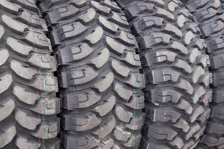 Black car tires in auto store, closeup