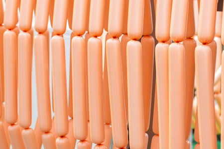 sausages production line, sausages hang in a row