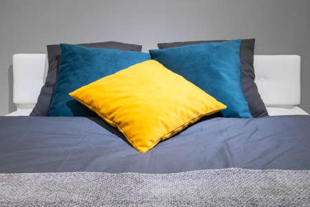 Big comfortable bed in hotel roomの写真素材