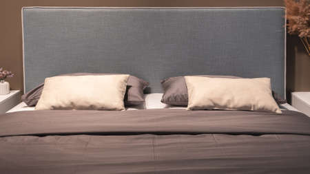 Big comfortable bed in hotel roomの写真素材