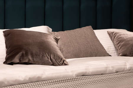 Big comfortable bed in hotel roomの写真素材