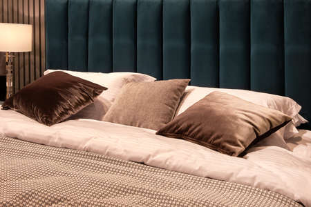 Big comfortable bed in hotel roomの写真素材