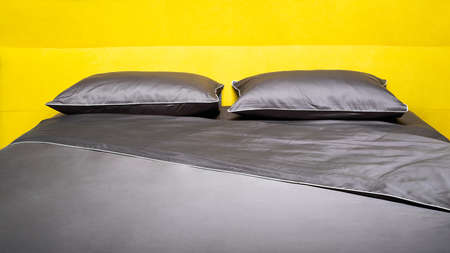 Big comfortable bed in hotel roomの写真素材