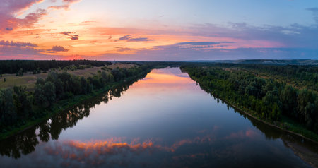 Aerial panoramic landscape with sunset over the river and beautiful clouds on the sky.の写真素材