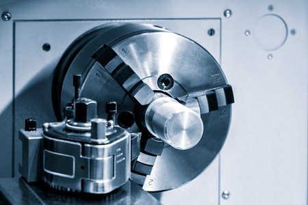 Metal machine tools industry. The lathe machine finishing cut the steel shaft parts by lathe tools. The metalworking process by turning machine.の写真素材