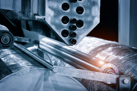 The operation of automatic plastic bag production machine. Close-up of the roller of the...