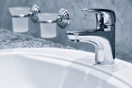 Water tap, faucet. Flow water in bathroom with sink. Modern clean house. hygiene concept.