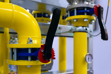 The gas pipeline is yellow with additional equipment, pipes and a valve to shut off the gas supply....