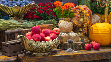 Pumpkins with fruits, bread, vegetables, grapes and flowerson rustic wooden table