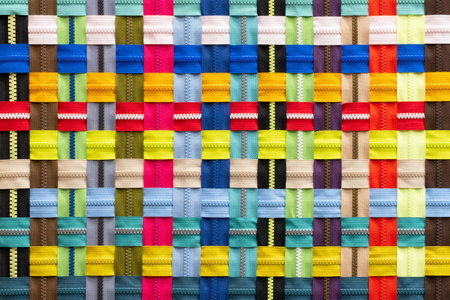 Multicolored Zippers or Zip Fasteners used for binding fabric or textile. Colorful Clasp Lockers Background or Pattern concept of Clothing Industry, Secret Keeper, Truth Revealing, Adhesion, Adherenceの写真素材
