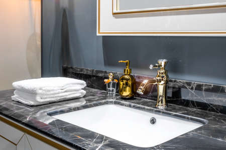Bathroom interior with sink and golden faucet.の写真素材