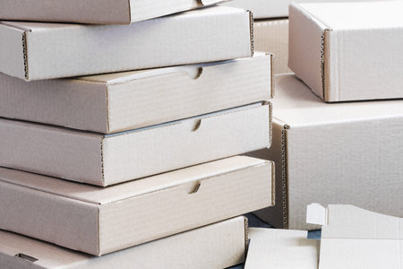 Stack of empty cardboard boxes for packaging close-upの写真素材