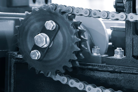 Gear chain drive shaft in conveyor belt is on production line. Timing chain of car, tensioners in engine. Industrial roller chain technology. Team work, business industrial conceptの写真素材