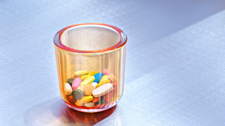 Pills and medicine bottles on glass, medical concept