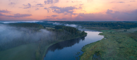Aerial panoramic landscape with sunset over the river with islands and beautiful clouds on the sky.の写真素材