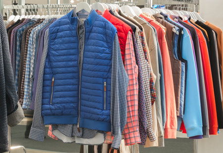 Fashion clothes on clothing rack - bright colorful closet. Closeup of rainbow color choice of trendy female wear on hangers in store closet or spring cleaning concept. summer home wardrobe.の写真素材