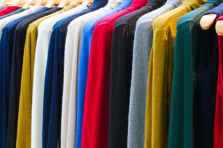 Fashion clothes on clothing rack - bright colorful closet. Closeup of rainbow color choice of trendy female wear on hangers in store closet or spring cleaning concept. summer home wardrobe. sweatshirtsの写真素材