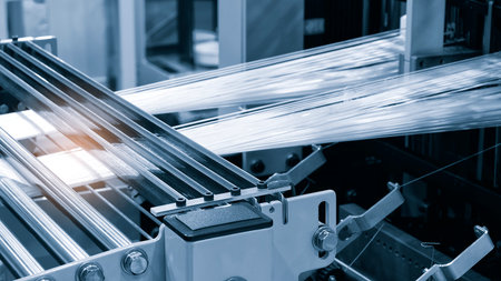 Coils of synthetic textile thread at industrial weaving manufacturing machineの写真素材