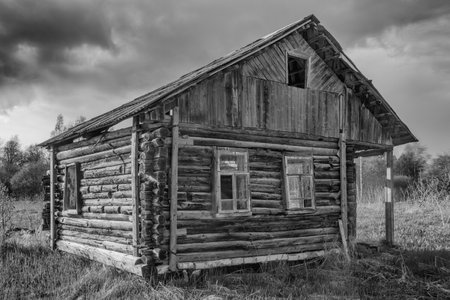 Old destroyed wooden house. black and white photoの写真素材