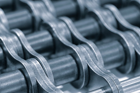 Gear chain drive shaft in conveyor belt is on production line. Timing chain of car, tensioners in engine. Industrial roller chain technology. Team work, business industrial conceptの写真素材